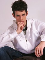 Cute twink Daniel masturbates on a bean bag chair.