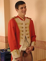 Marching band boy play his horn in front of the mirror