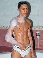 Latino boy having bubble bath in cozy tub